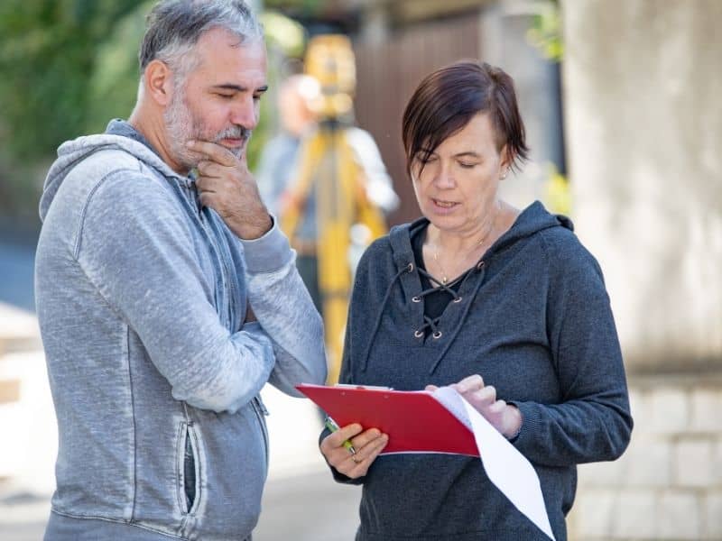 Homeowner meeting with a survey professional while comparing property survey companies